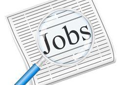 Magnifying glass focused on the Jobs section of a newspaper